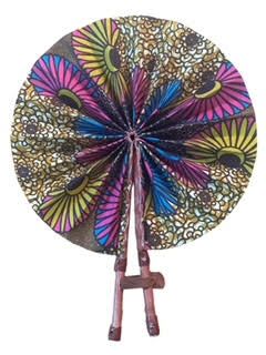 Colorful patterned fan on a wooden stand.