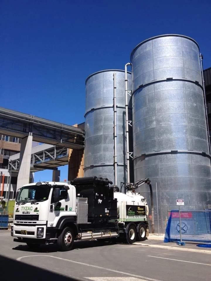 Truck Parked Beside Two Large Silver Silos — Hydro Excavation on the Sunshine Coast, QLD