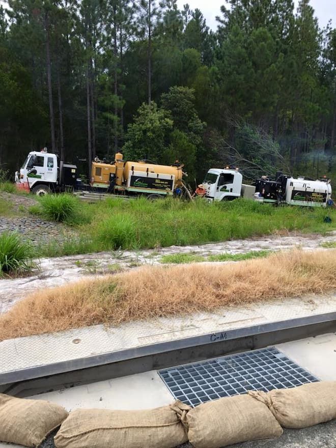 Trucks Parked by a Field — Vacuum Excavation in Logan, QLD