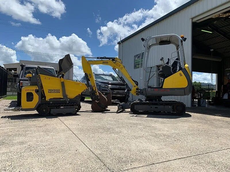 Construction Vehicles Parked Outside A Building — Vacuum Excavation in Gympie, QLD