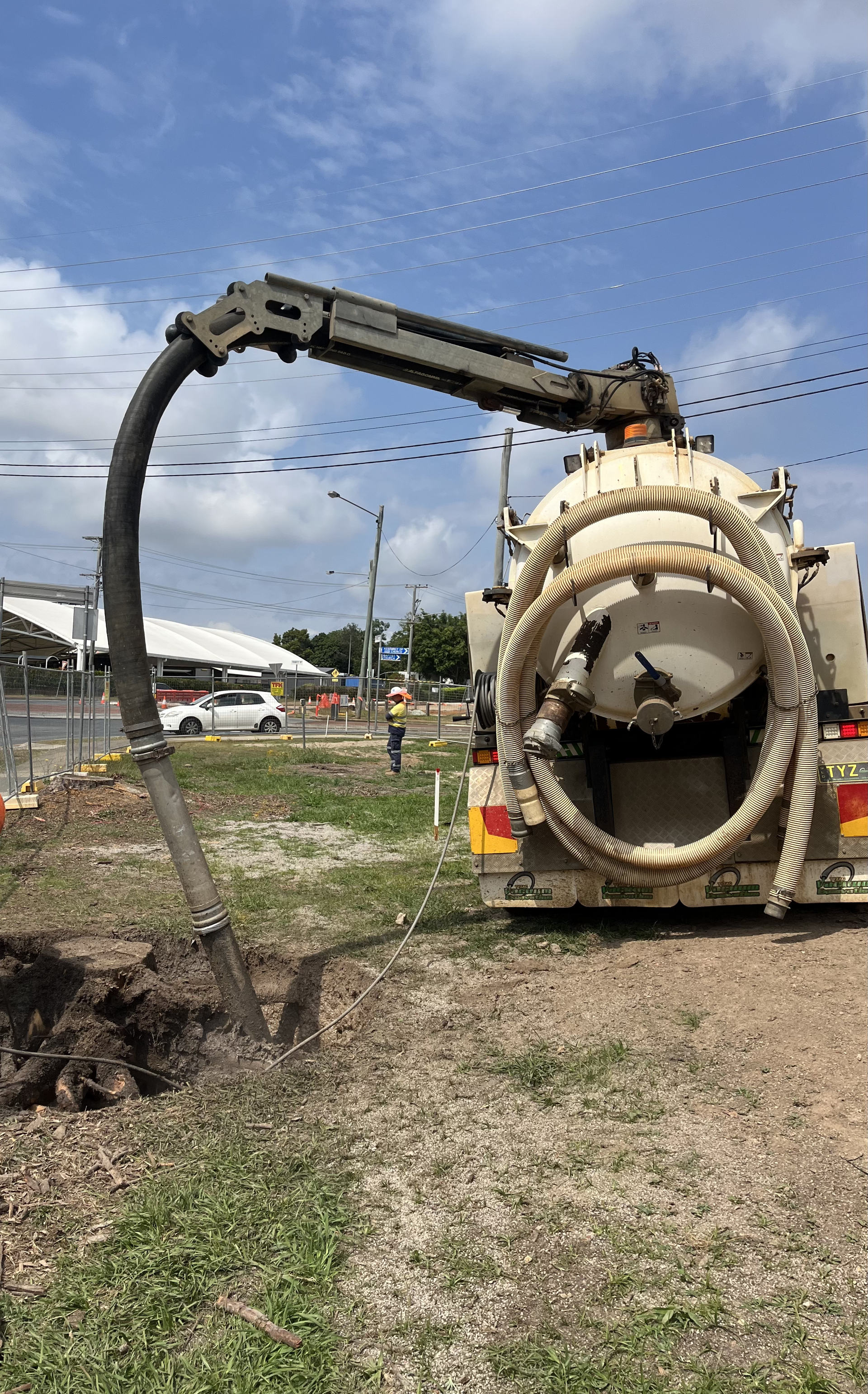 A Vacuum Truck Is Cleaning A Hole In The Ground — Tyzac Vacuum Excavation in Sunshine Coast, QLD