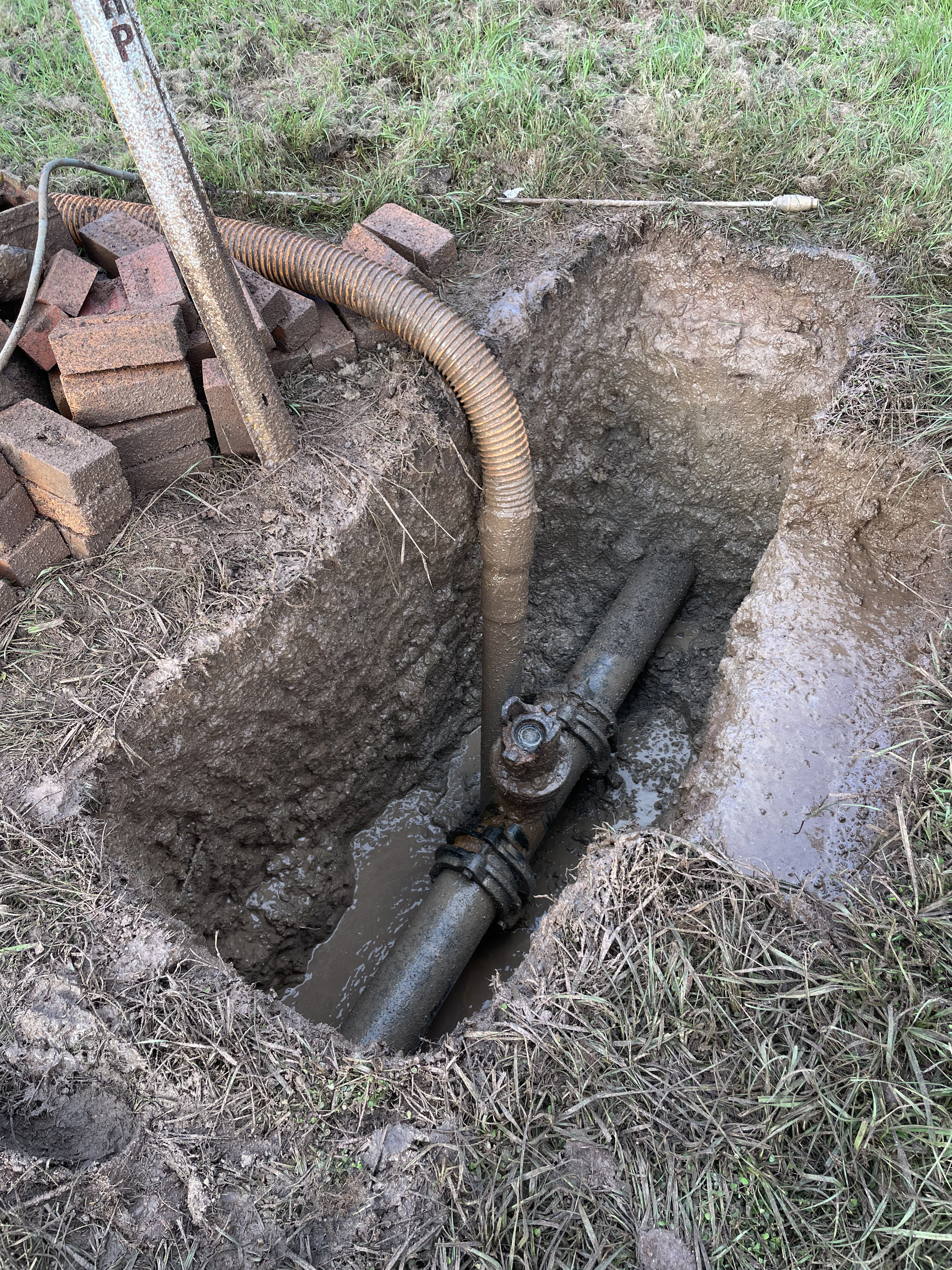 A Hose Is Being Used To Remove A Pipe From A Hole In The Ground — Tyzac Vacuum Excavation in South Brisbane, QLD