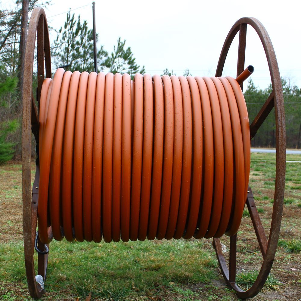 Large Spool of Orange Hose Sitting in the Grass — Vacuum Excavation in South Brisbane, QLD