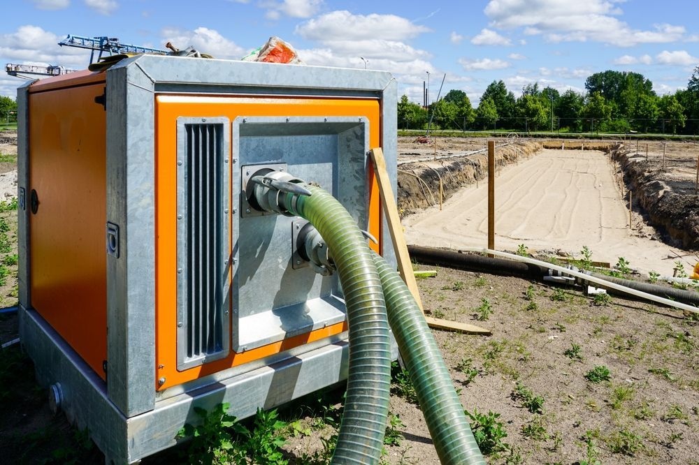 An Industrial Water Pump Being Used To Drain Water From a Construction Site — Vacuum Excavation in Caloundra, QLD