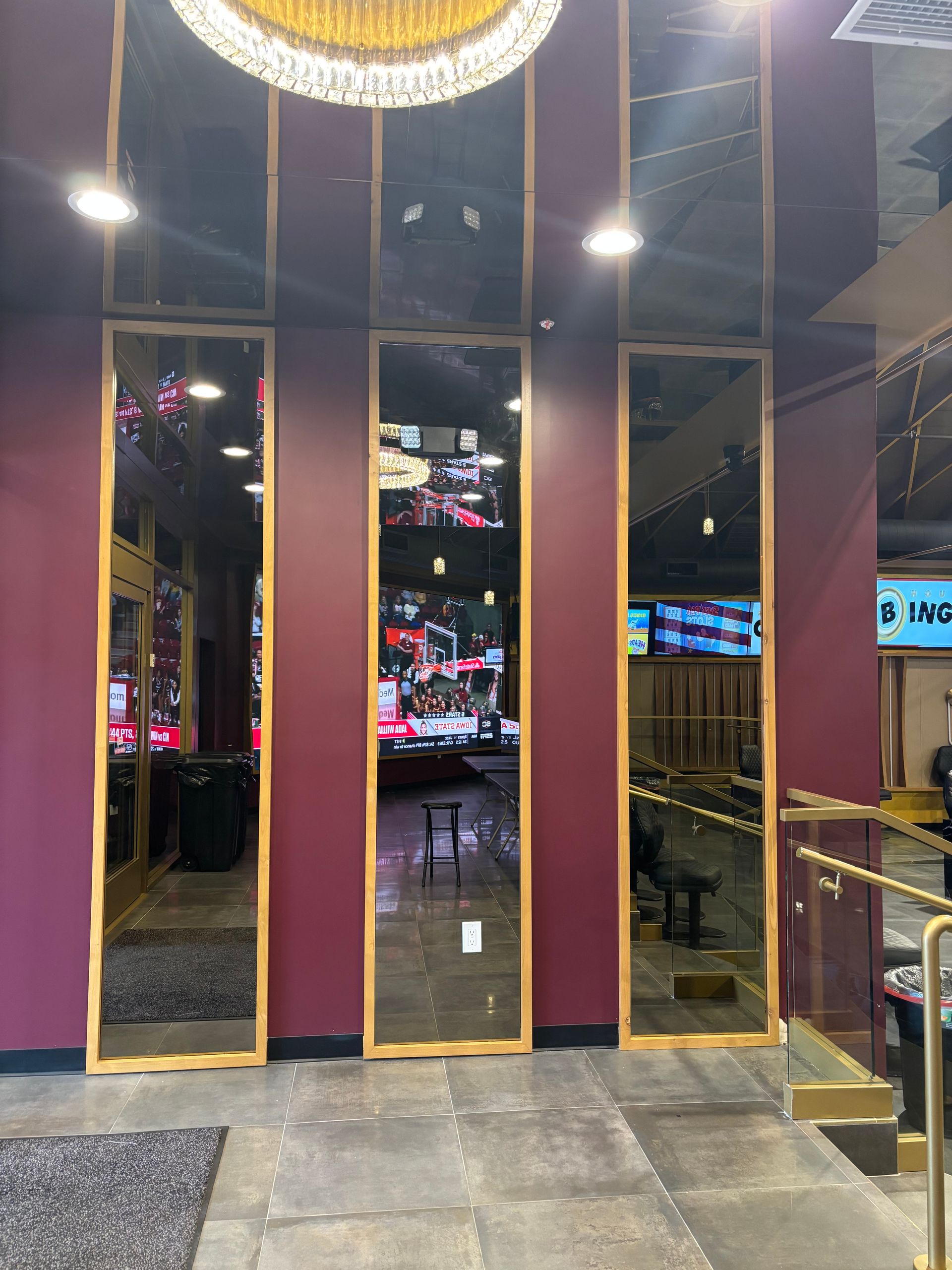Black storefront with glass windows and doors; clothing display inside.