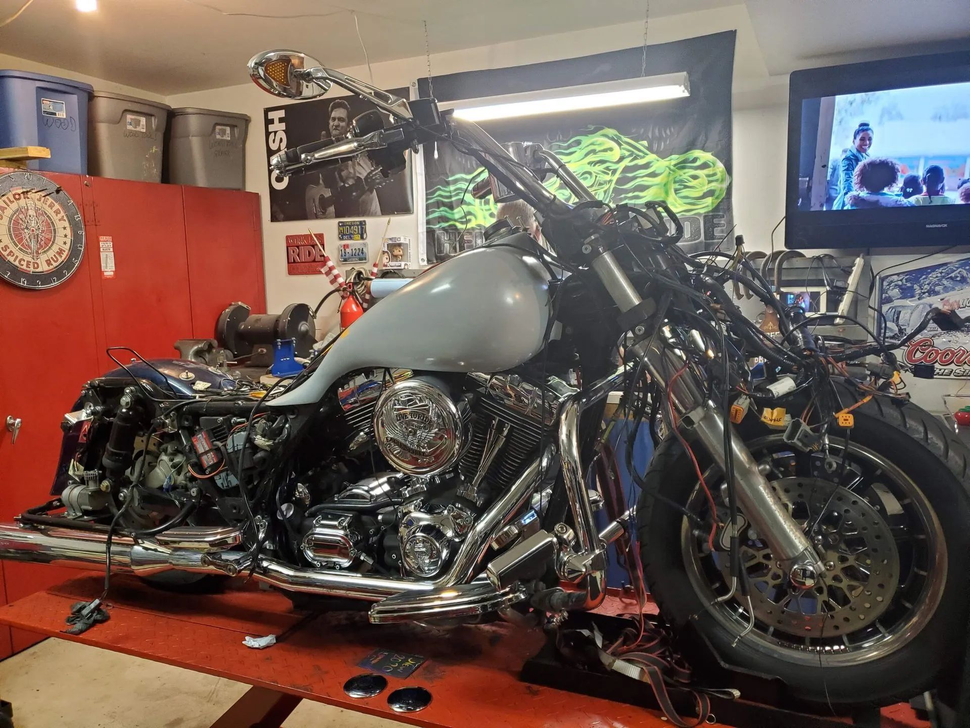 A motorcycle is sitting on a lift in a garage.