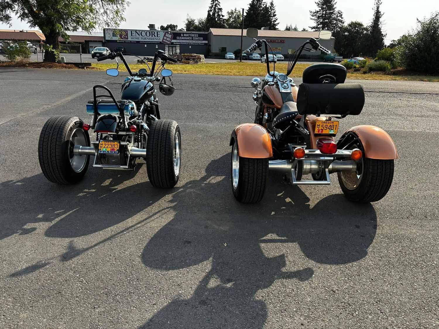 Two motorcycles are parked next to each other in a parking lot