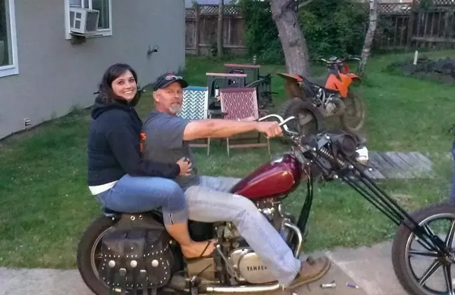 A man and a woman are sitting on a motorcycle.