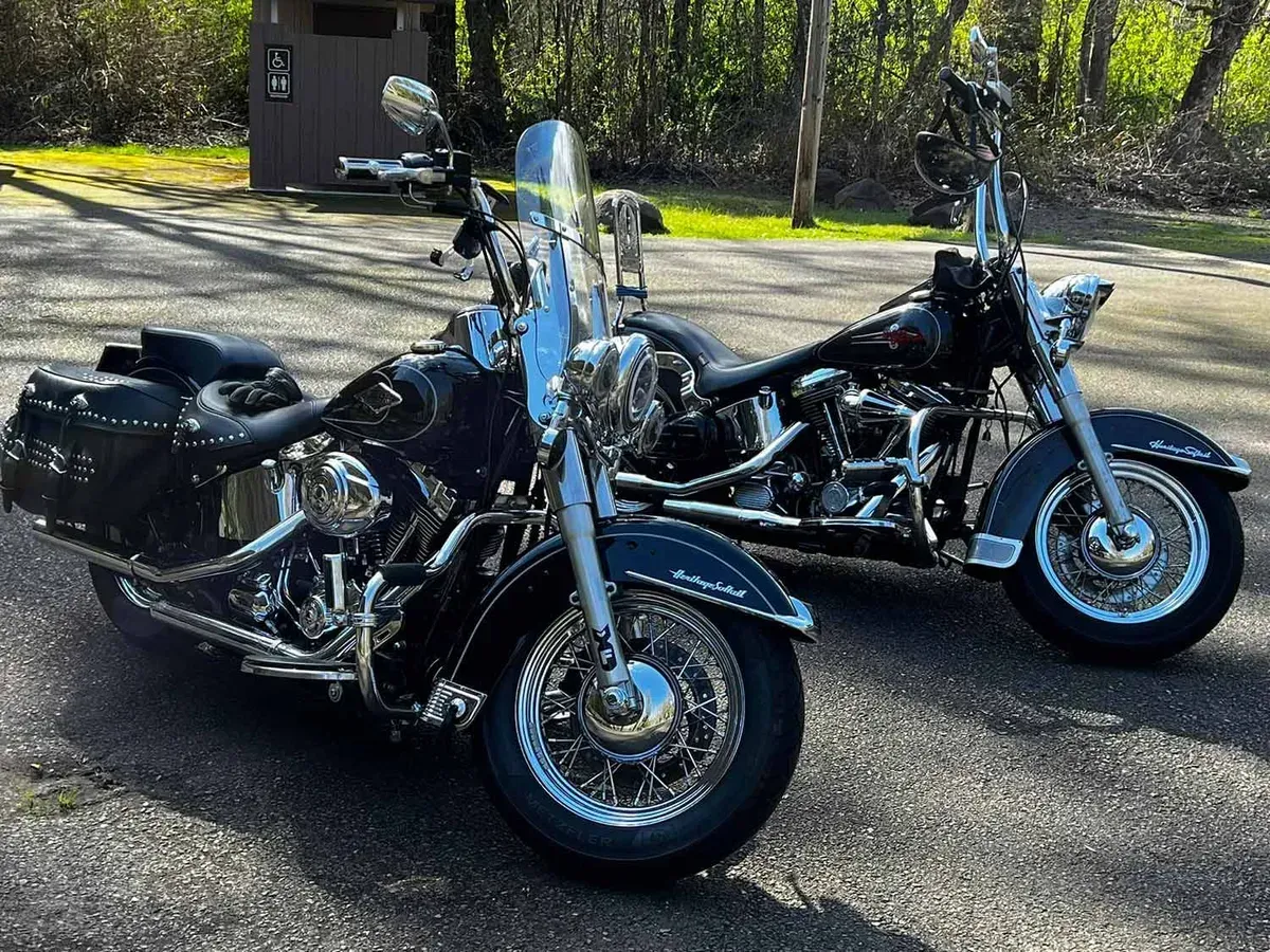Two harley davidson motorcycles are parked next to each other in a parking lot.