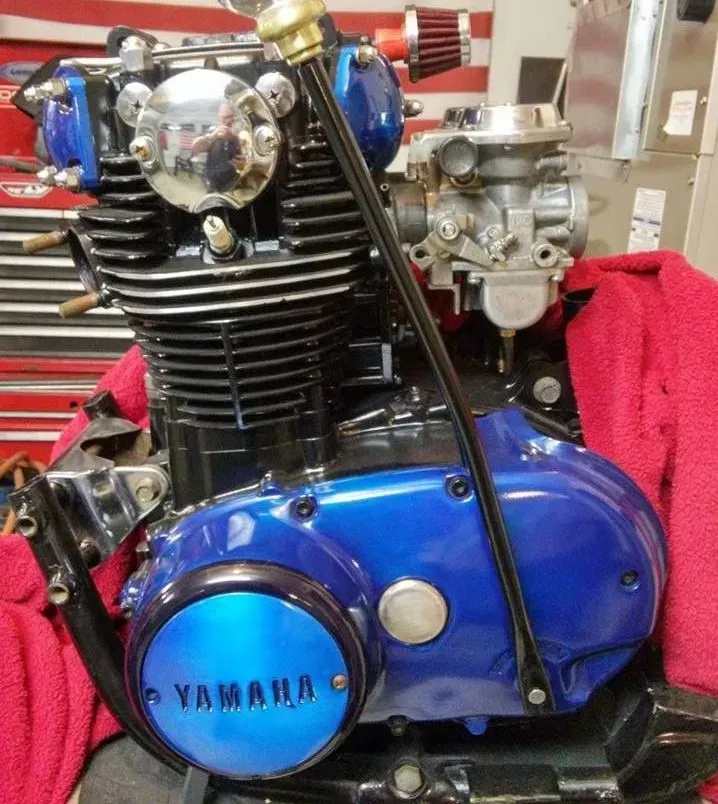 A blue yamaha engine is sitting on a red towel