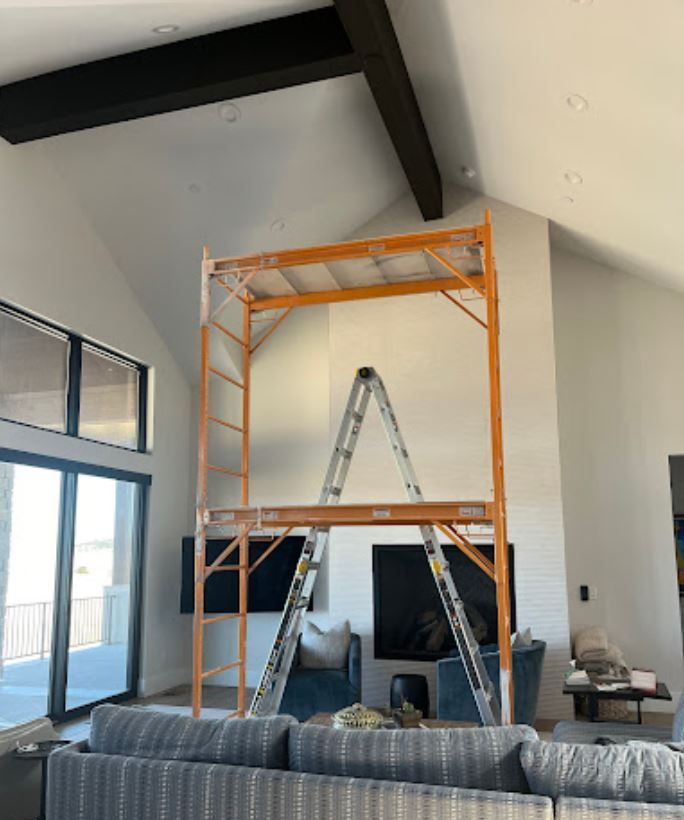 A living room with a scaffolding in the middle of it
