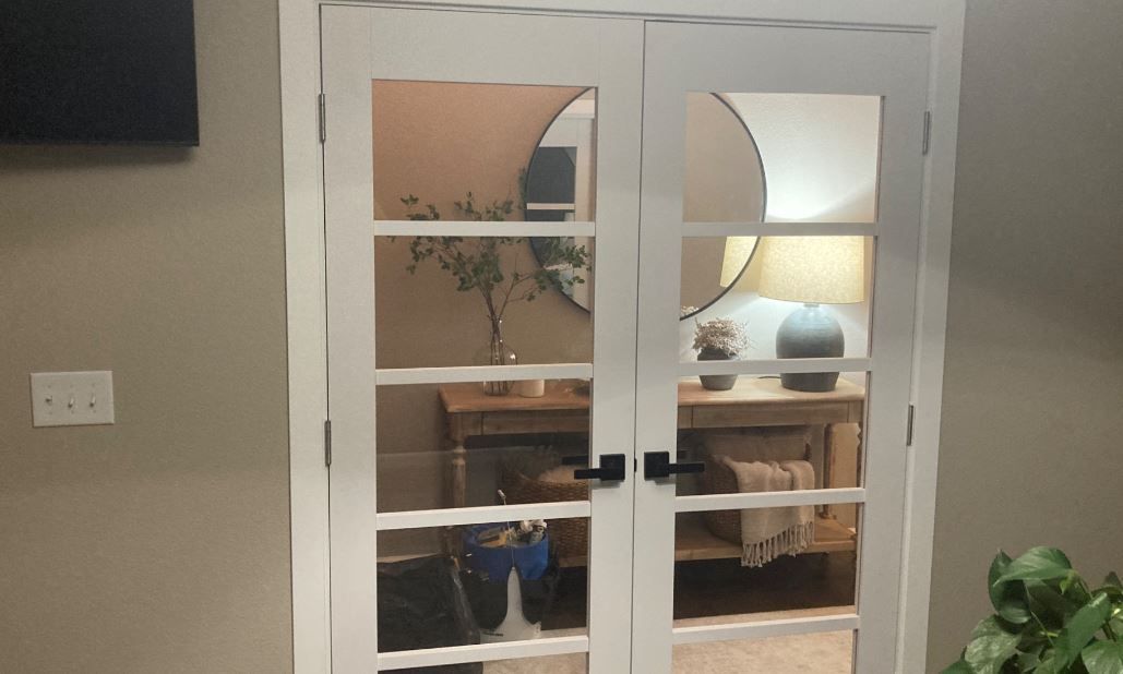 A pair of french doors leading into a living room.