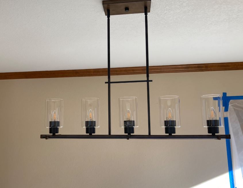 A chandelier with clear glass shades is hanging from the ceiling