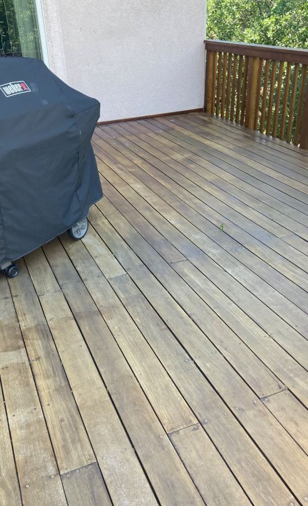 A wooden deck with a grill on it