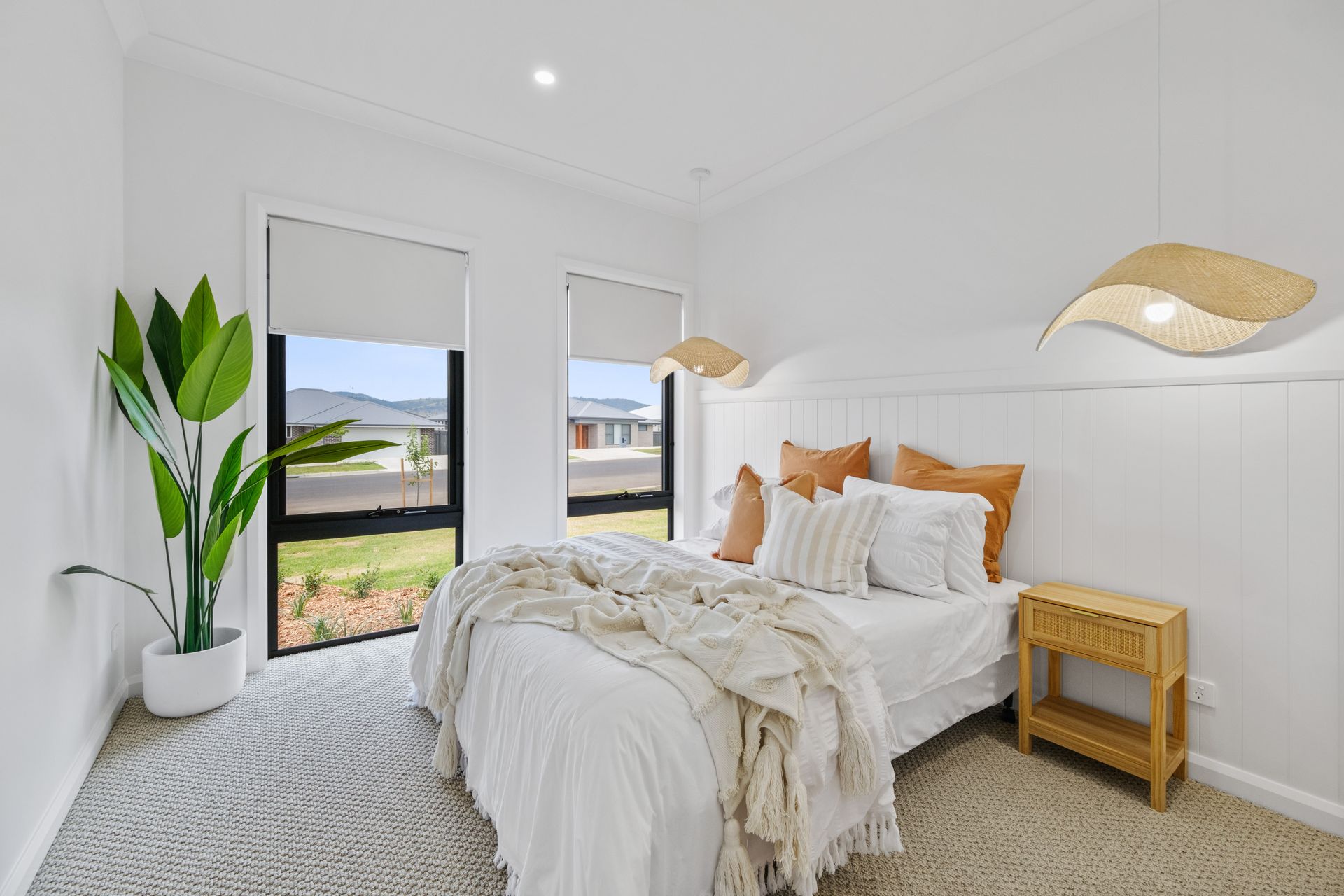 A bedroom with a bed , nightstand , and window.