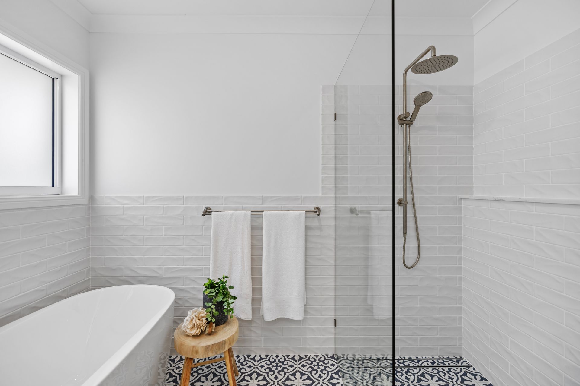 A bathroom with a bathtub and a walk in shower.