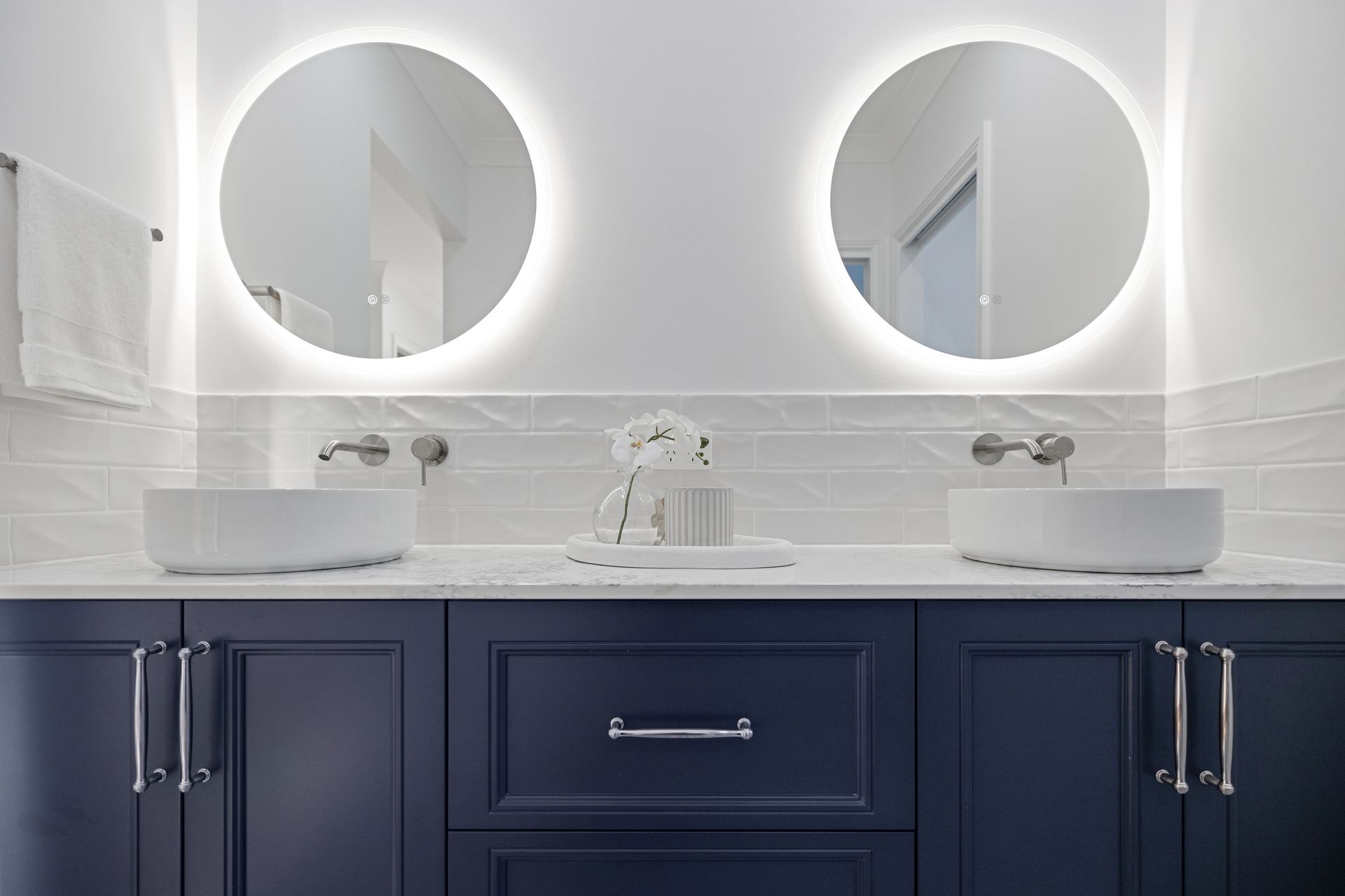 A bathroom with two sinks and two mirrors.