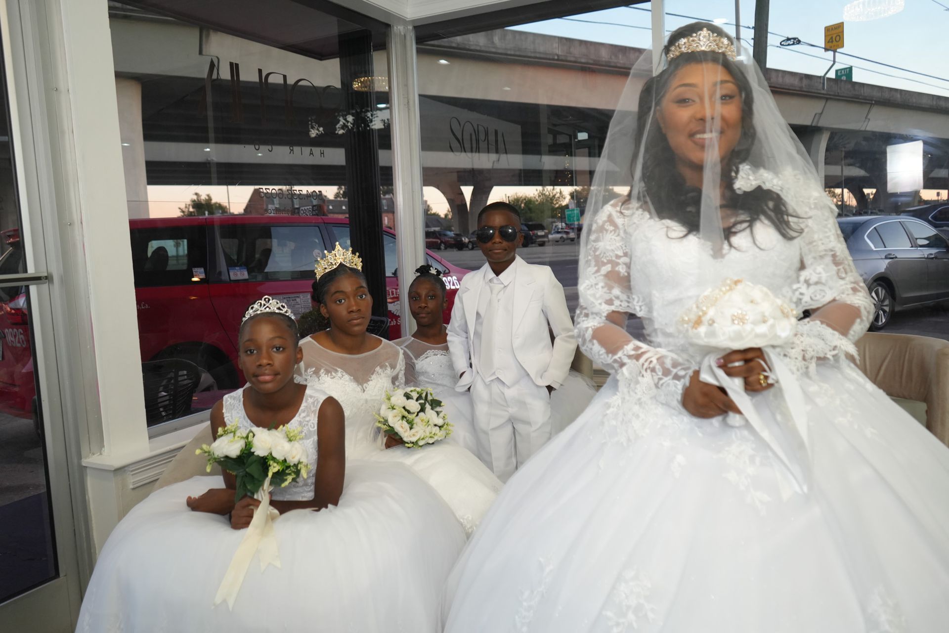 A group of people in white dresses are posing for a picture.