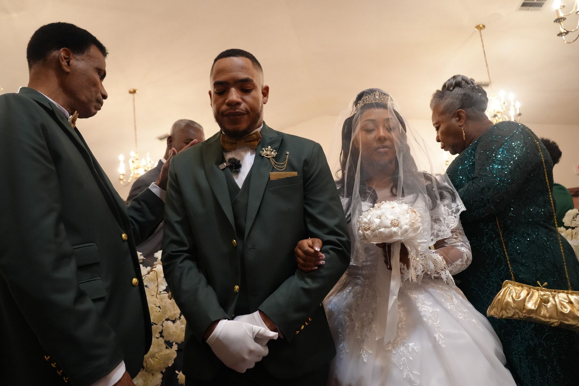 A bride and groom are walking down the aisle at their wedding