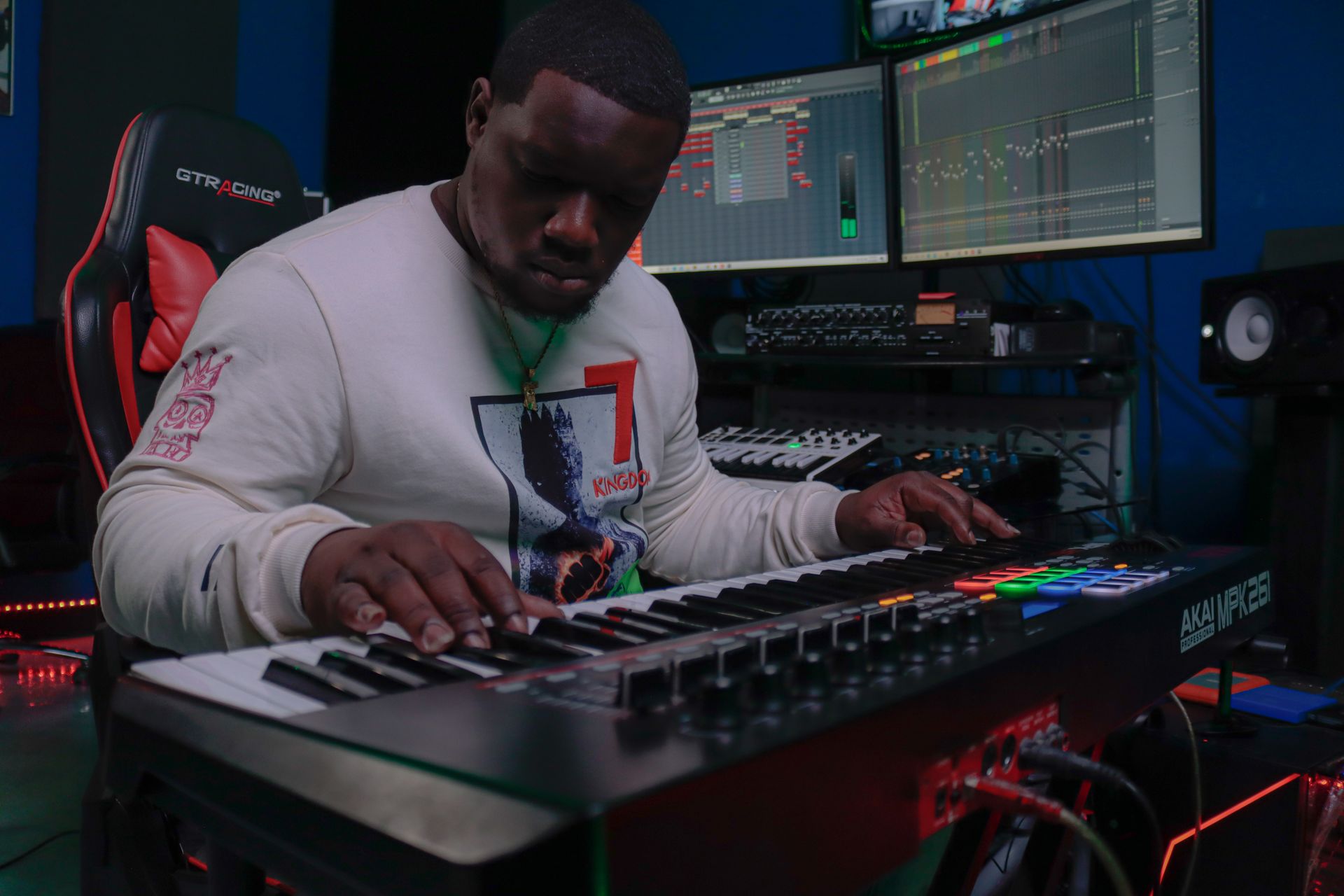 A man is playing a keyboard in a studio.