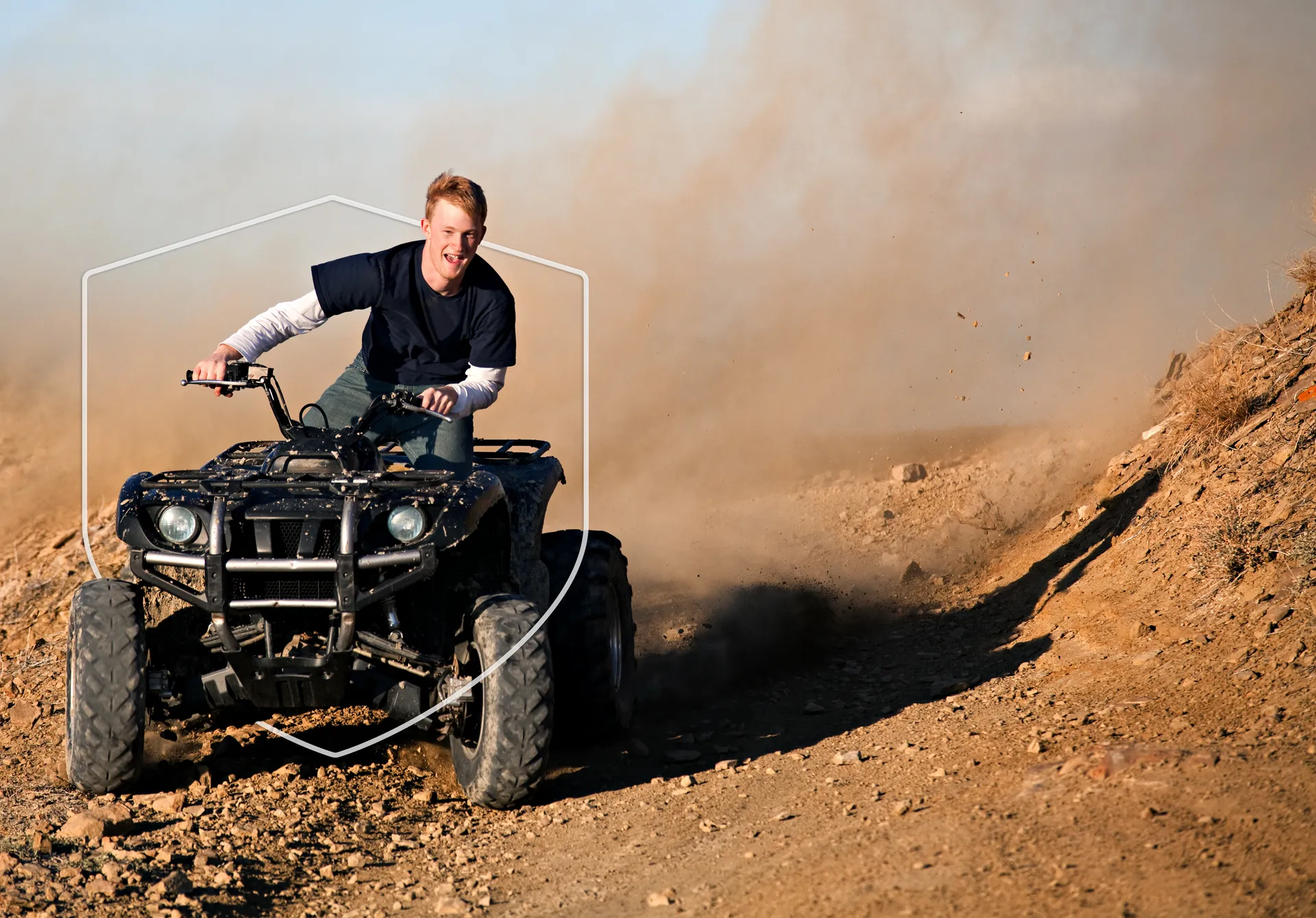 A kid on a ATV on a dirt trail