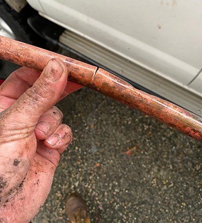 Cracked Copper pipe from tree root pressure