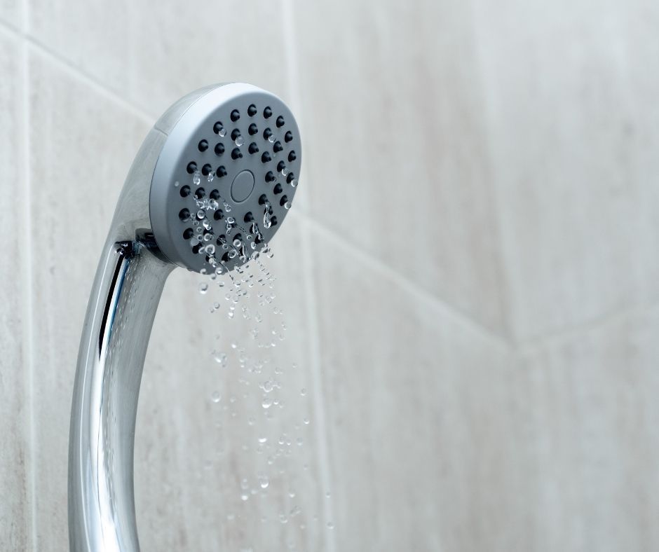 Showerhead with weak water flow, suggesting low pressure issues.