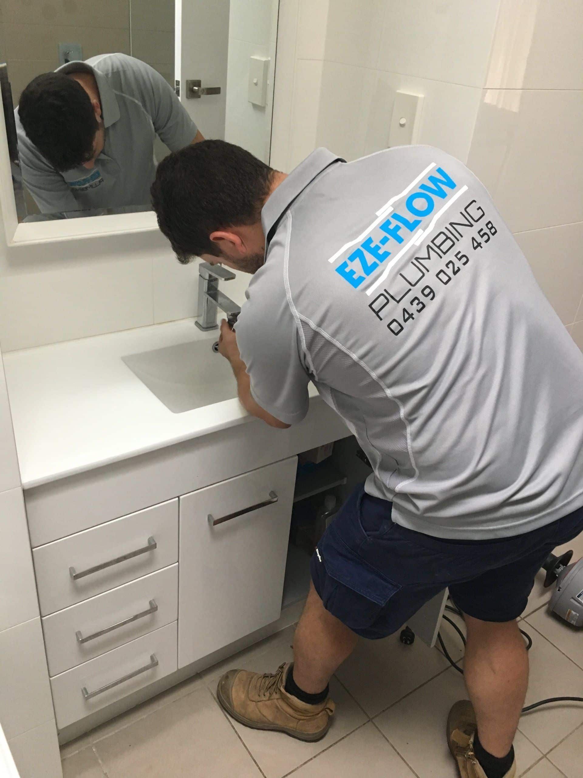 Eze-flow owner man Chris fixing tap