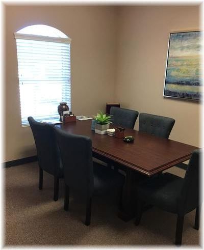Private consultation room with table and chairs designed for comfortable discussions in a quiet office setting