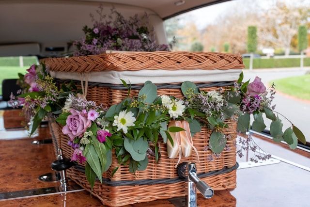 A wooden casket being transported for a cremation service in Fernandina Beach, FL