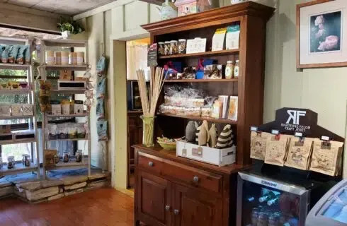 A store filled with lots of shelves and a refrigerator.