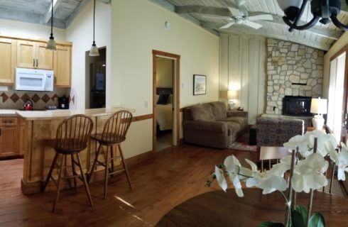 A living room with a table and chairs and a fireplace