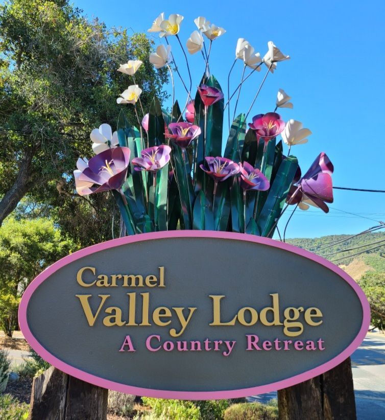 A sign for carmel valley lodge a country retreat