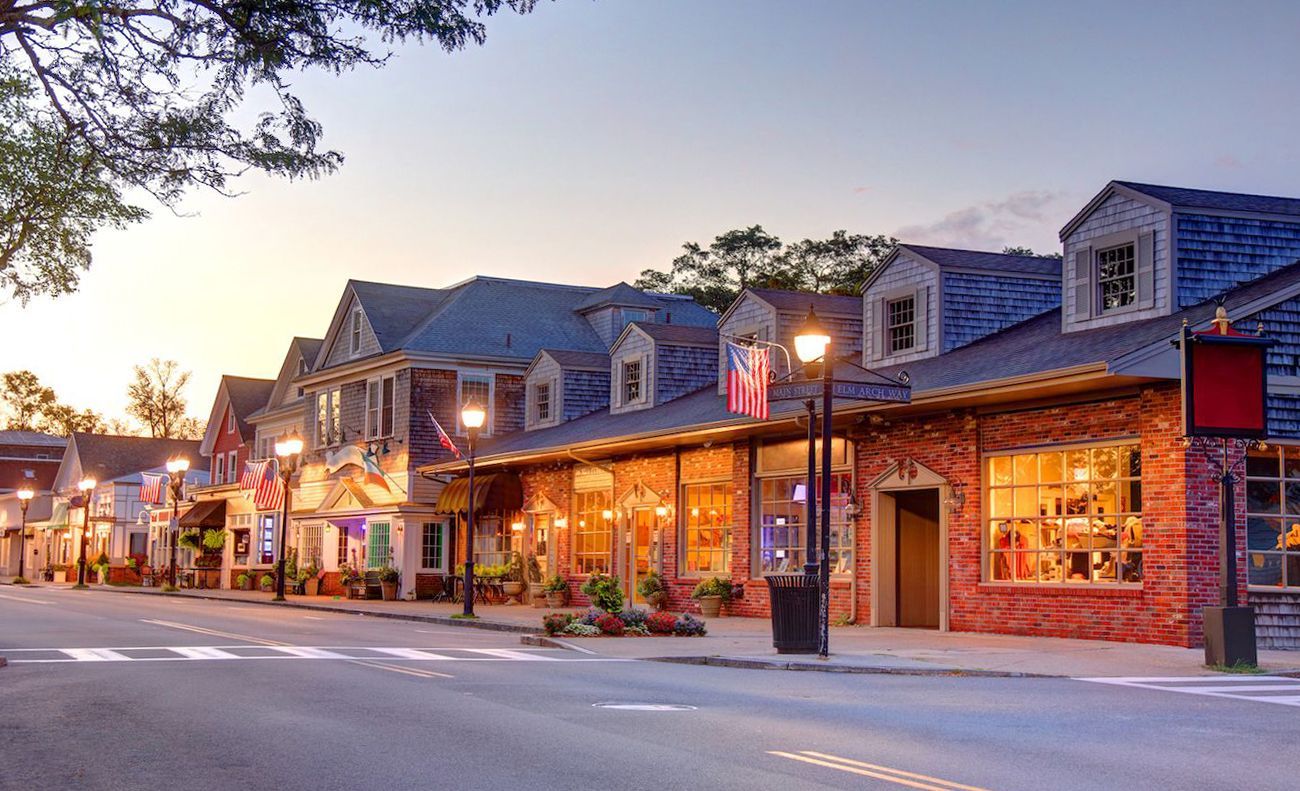 A row of buildings are lined up on the side of a street in a small town.