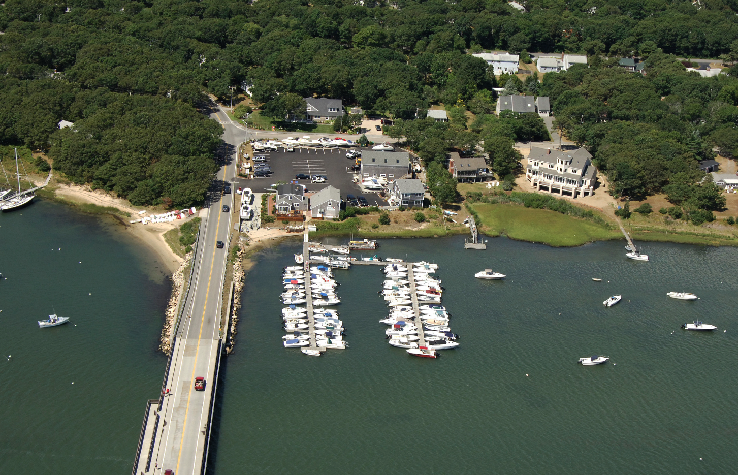 An aerial view of a marina with boats and a bridge
