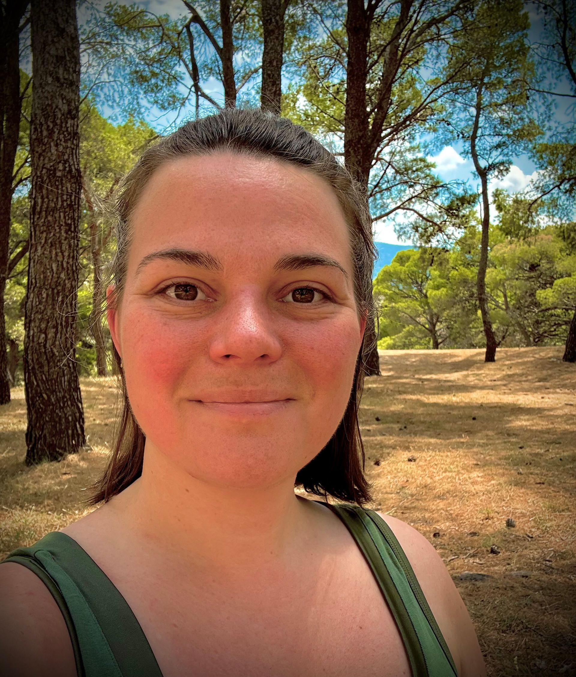 Underviser Chanet i sort bluse smiler foran en plante.