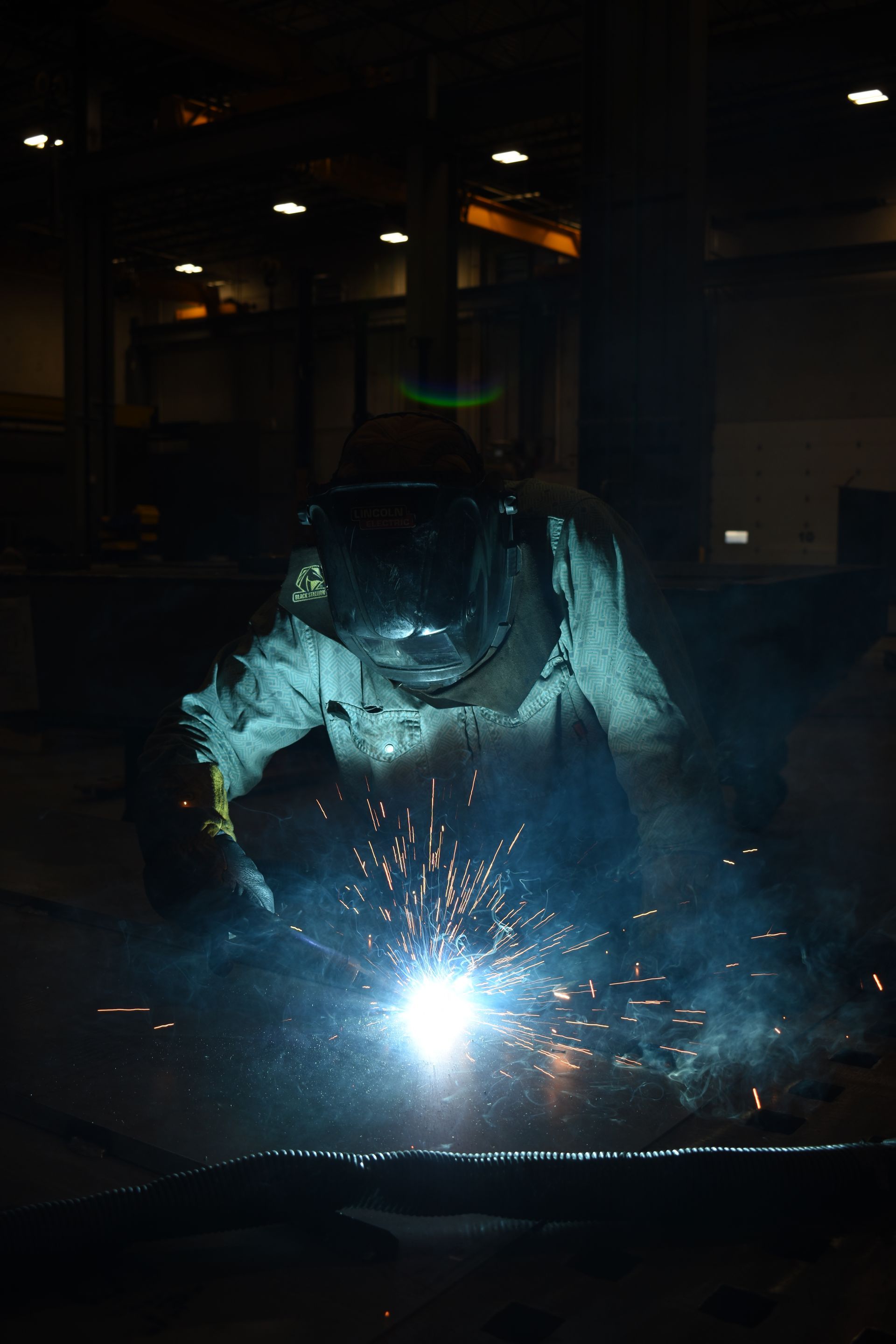 Welder performing metal fabrication at United Alloy factory.