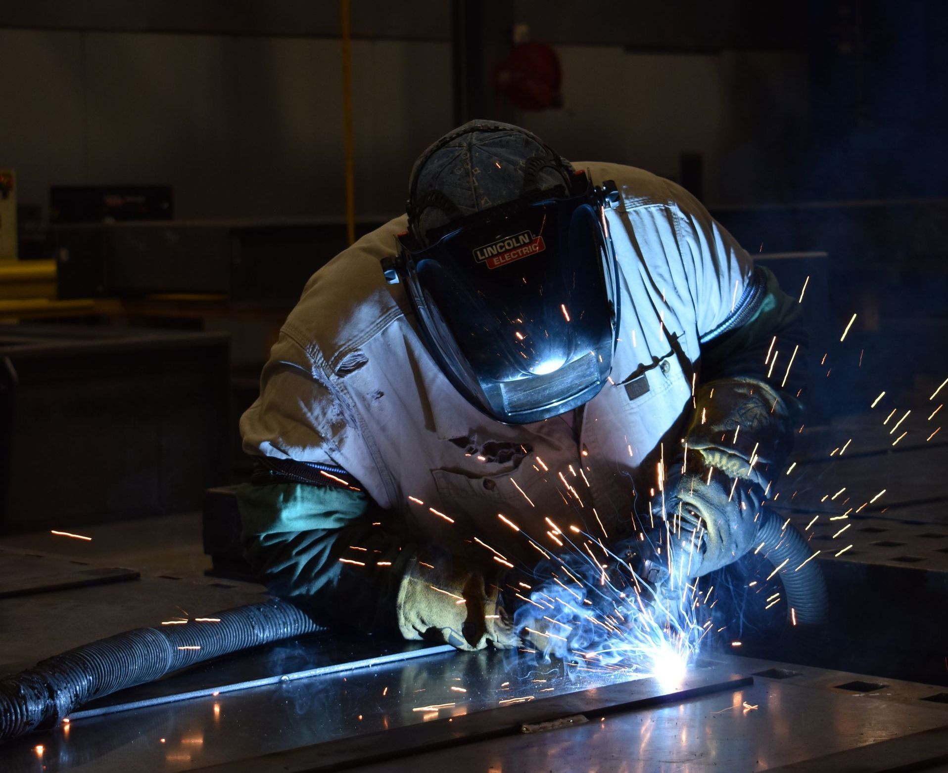 Welder performing metal fabrication at United Alloy factory.