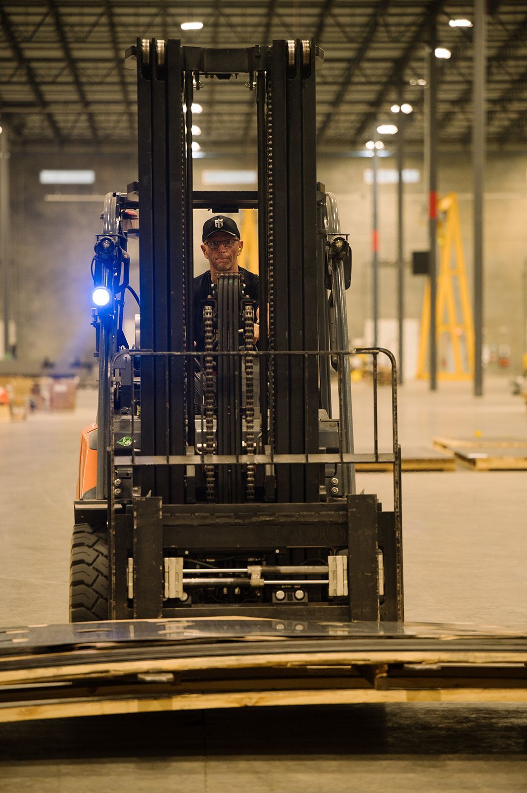 Two material handlers moving raw materials at United Alloy manufacturing facility.