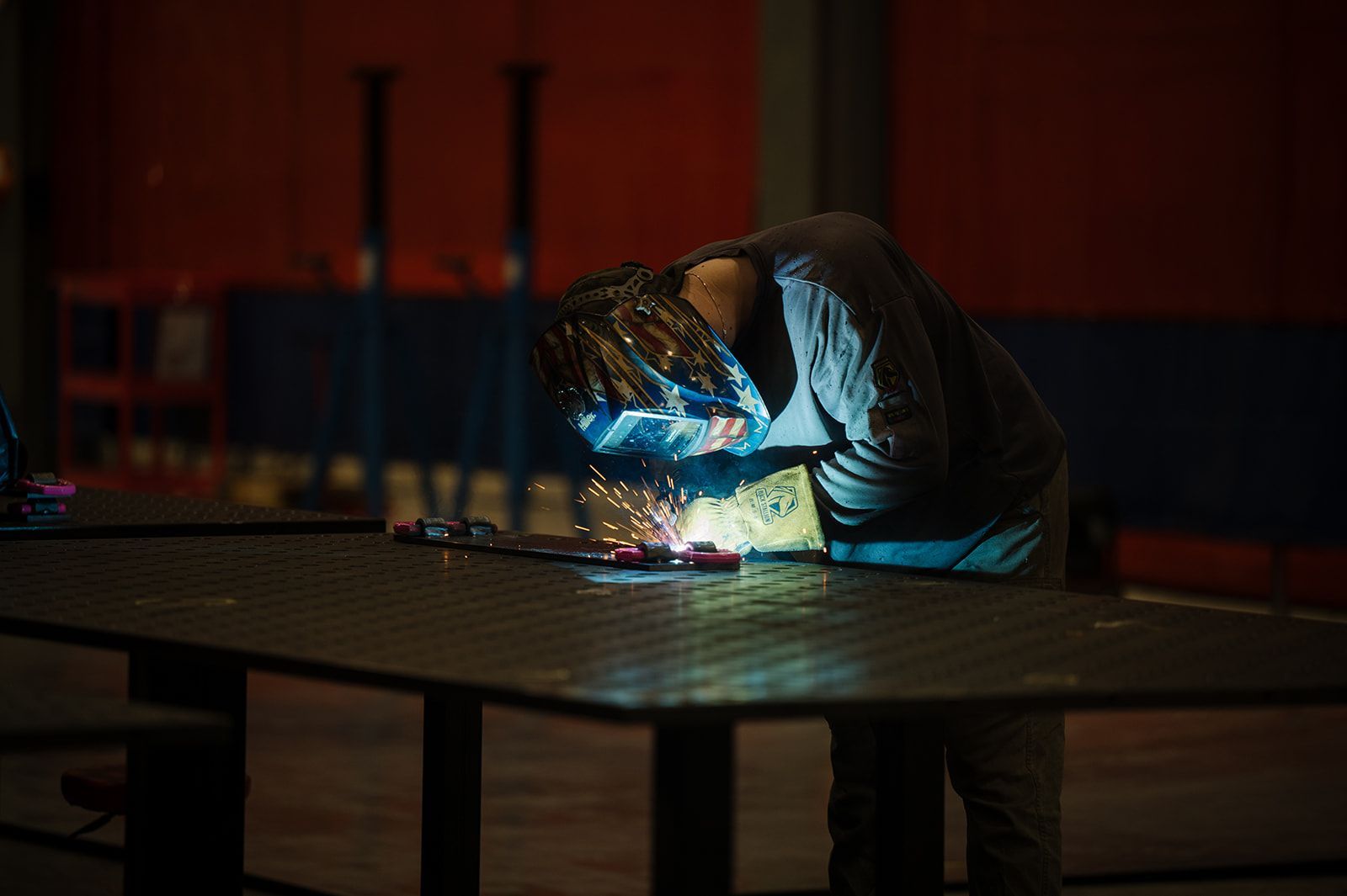 Detailed view of professional metal inert gas welding showing consistent bead quality on a steel chassis.