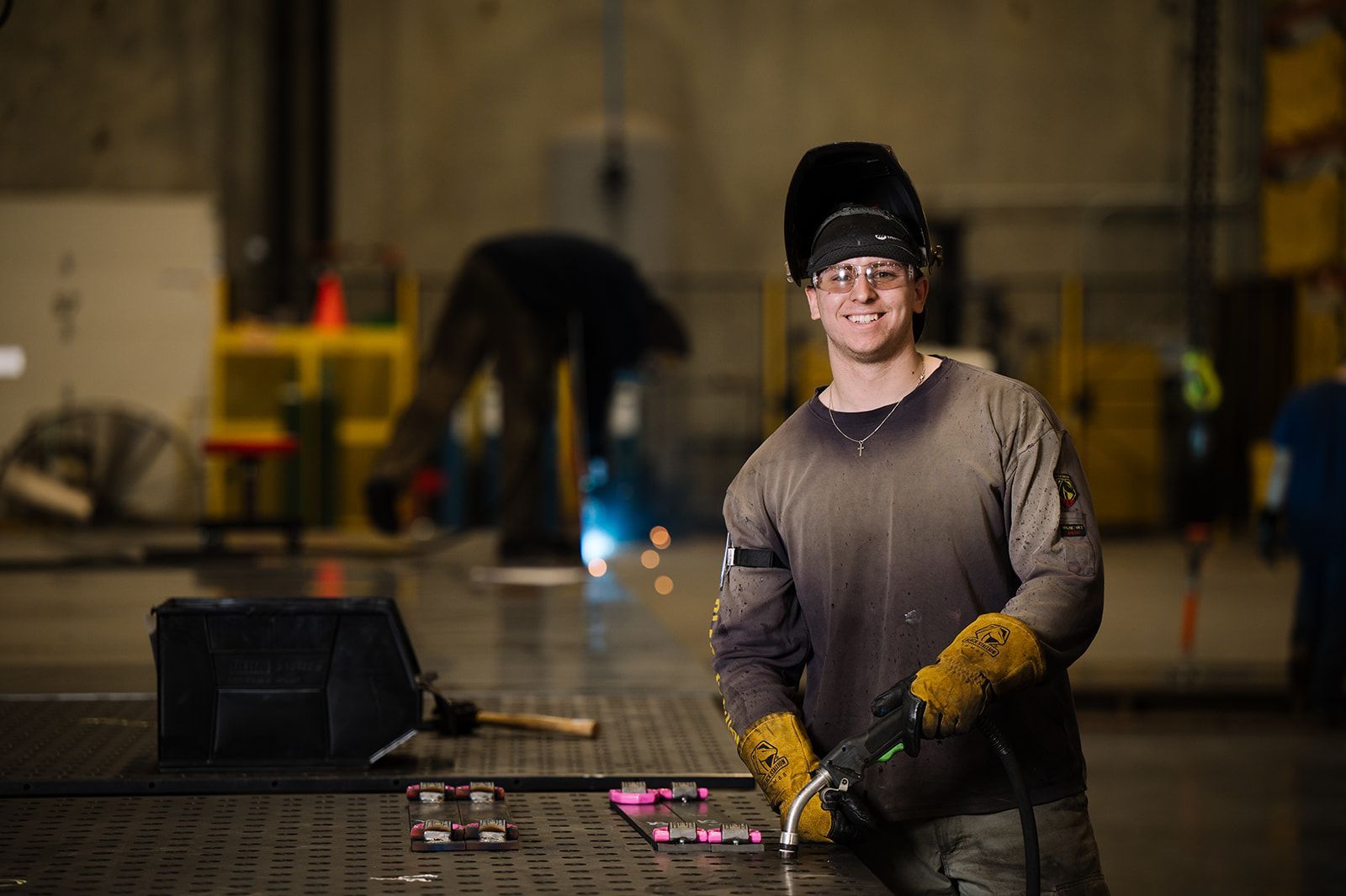 Welder performing metal fabrication at United Alloy factory.