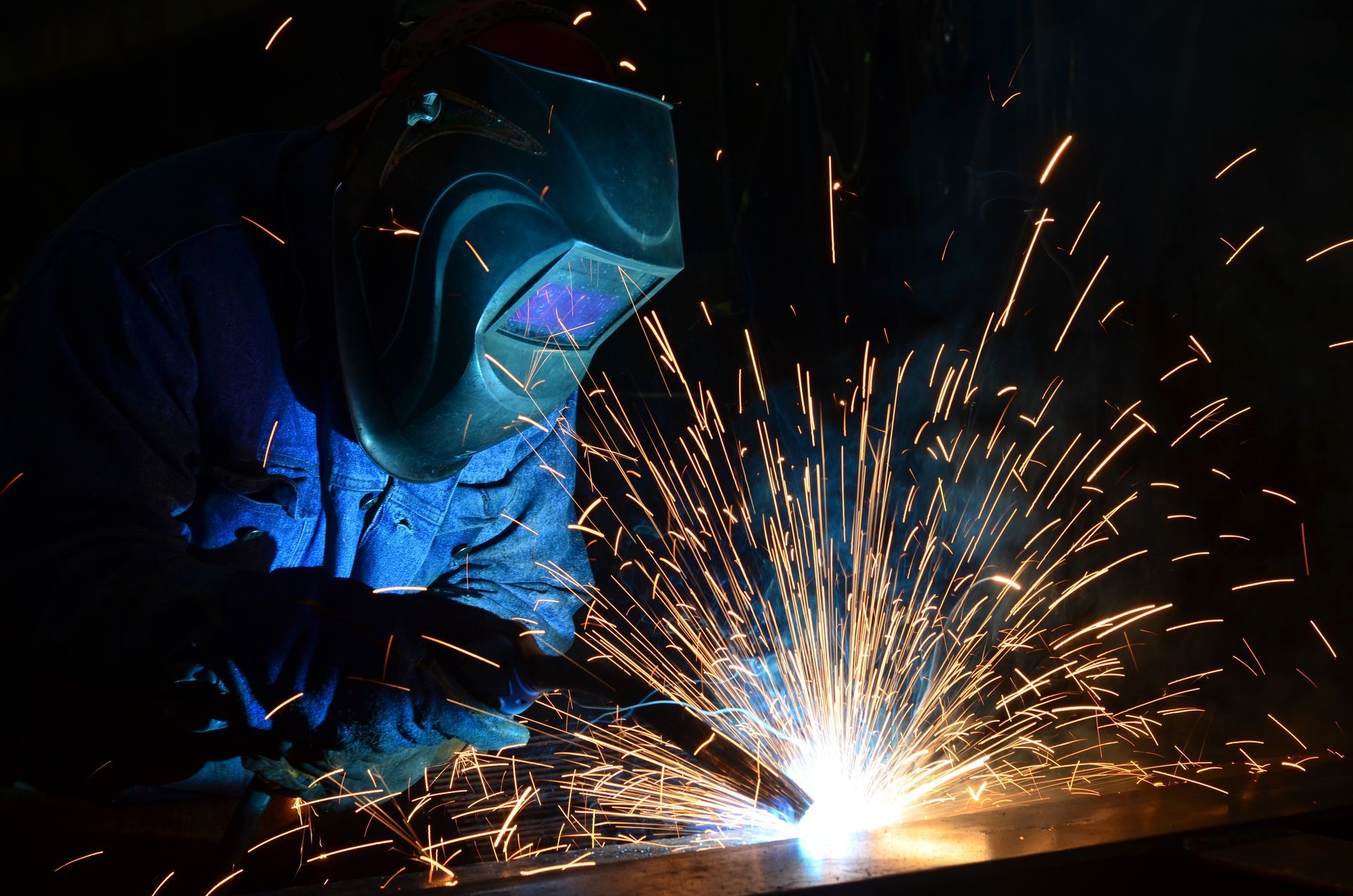 Welder performing metal fabrication at United Alloy factory.