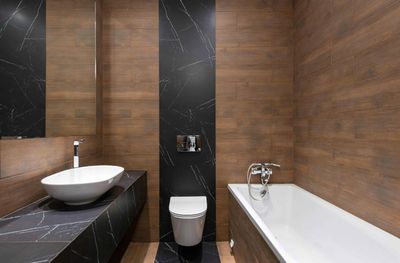 A bathroom with a sink , toilet , bathtub and mirror.