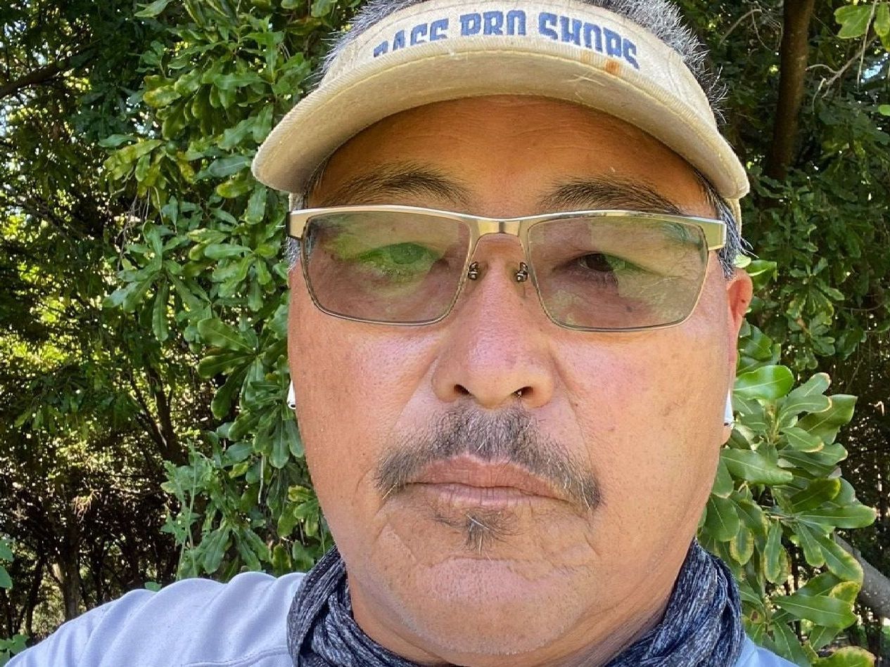 A man with a mustache and glasses is wearing a hat and sunglasses.