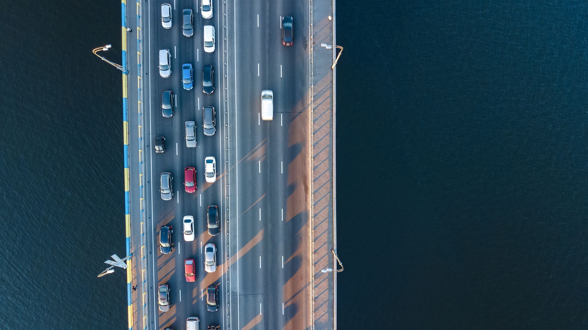 An aerial view of a busy bridge over a body of water.