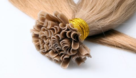 A close up of a bunch of hair extensions on a white surface.