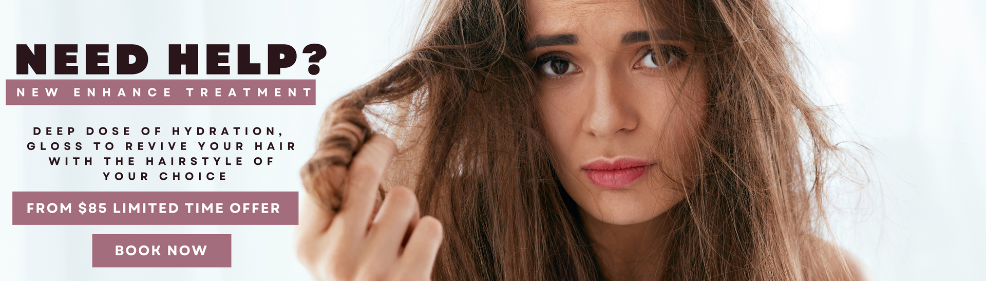 A woman with long hair is holding her hair in her hands.