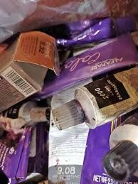 A pile of hair dye tubes sitting on top of each other.