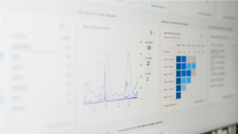 Analytics dashboard with line and bar graphs displaying data, blue tones.