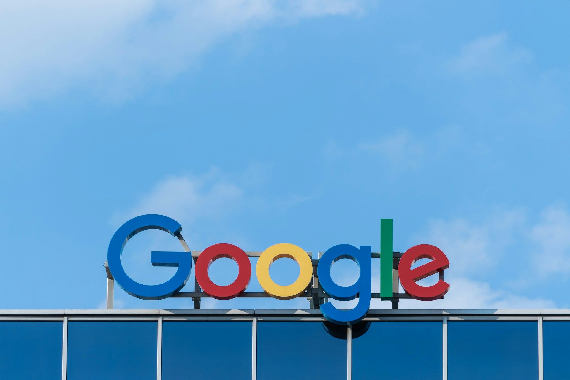 A google sign on top of a building with a blue sky in the background.